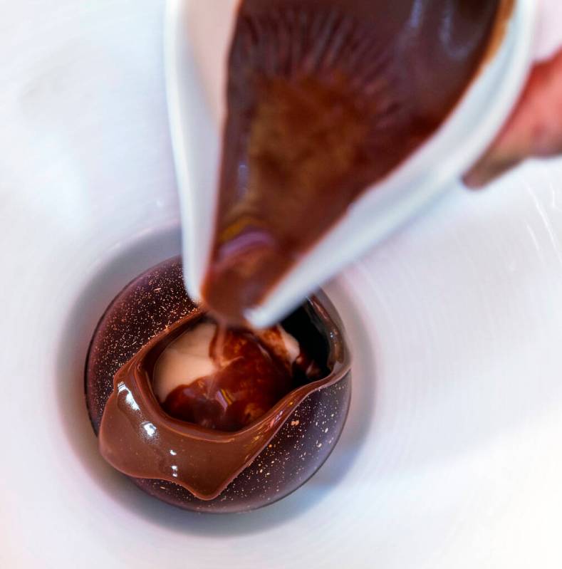 A chocolate ball with crème fraîche ice cream at Le Cirque restaurant within the Bellagio on ...
