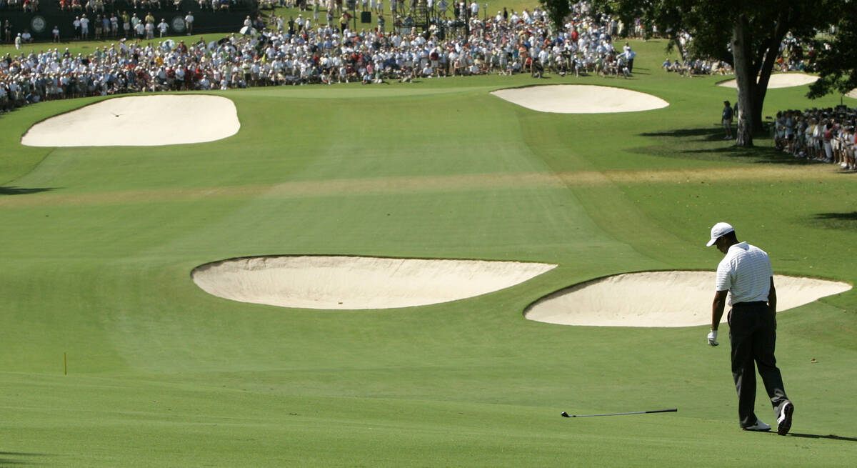 Tiger Woods throws his club on the 18th fairway during the first round of the 89th PGA Golf Cha ...