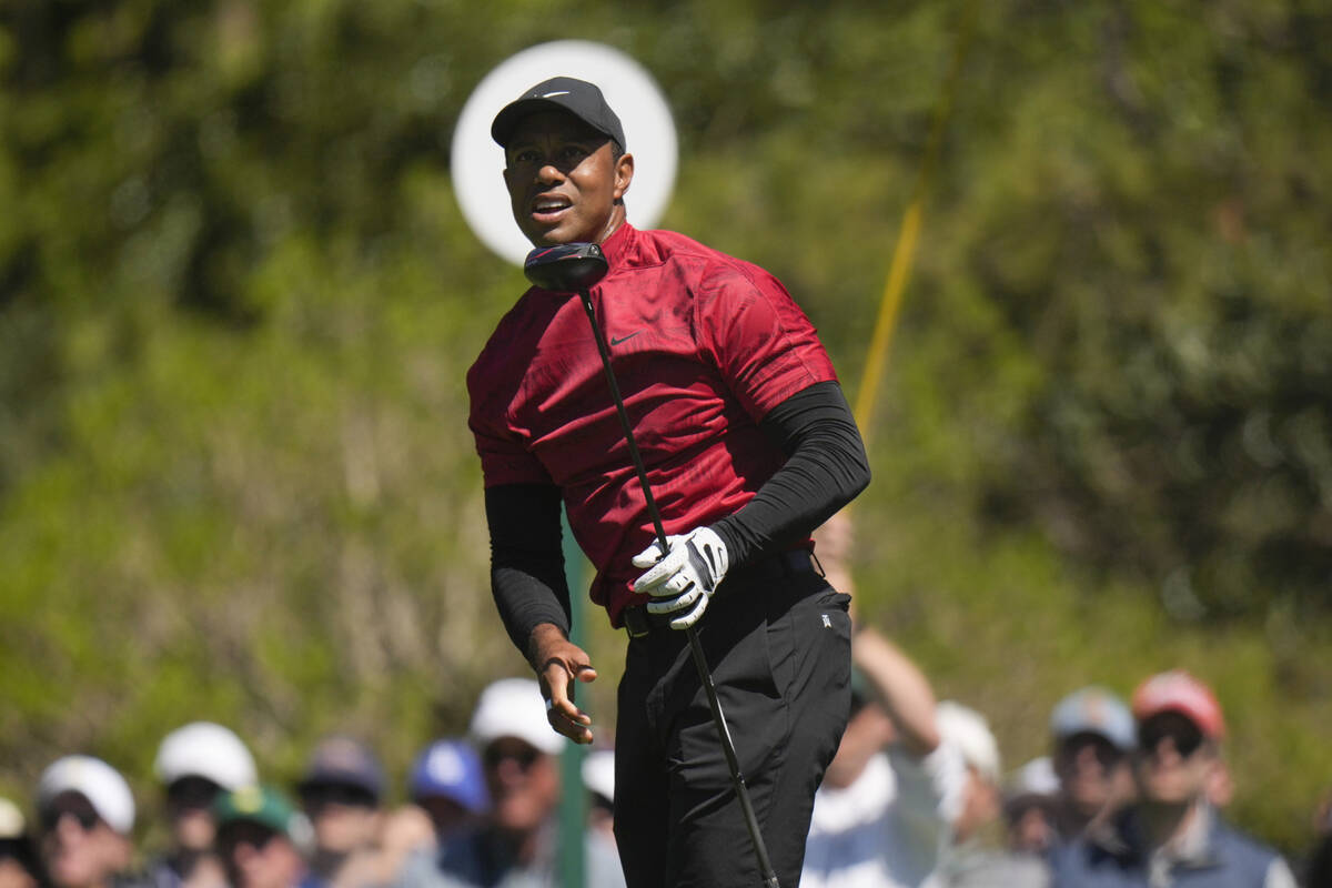Tiger Woods watches his tee shot on the fifth hole during the final round at the Masters golf t ...