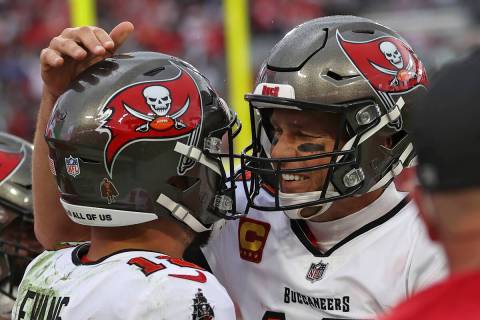 Tampa Bay Buccaneers quarterback Tom Brady, right, celebrates with wide receiver Mike Evans aft ...