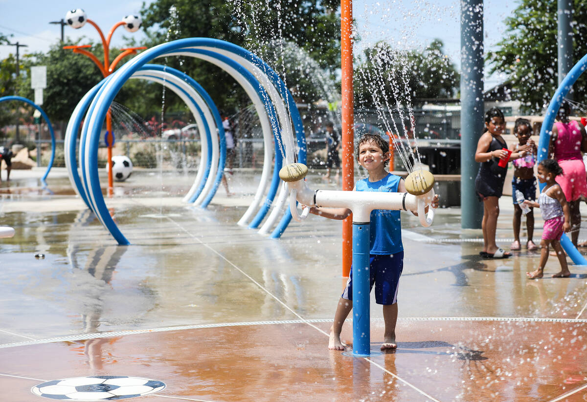 K.J. Lefear-Bleything, 5, plays with the water features at Baker Park in Las Vegas, Sunday, May ...
