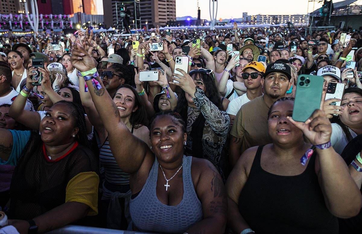 Fans react as Ja Rule performs during the Lovers & Friends music festival on Saturday, May ...