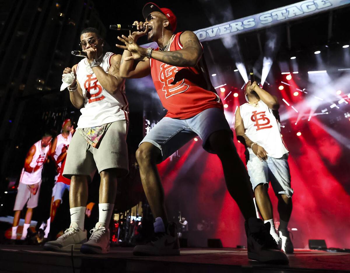 Chingy, center, joins Nelly, left, onstage during the Lovers & Friends music festival on Sa ...