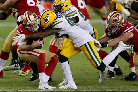 San Francisco 49ers quarterback Nick Mullens (4) is hit by Green Bay Packers cornerback Stanfor ...