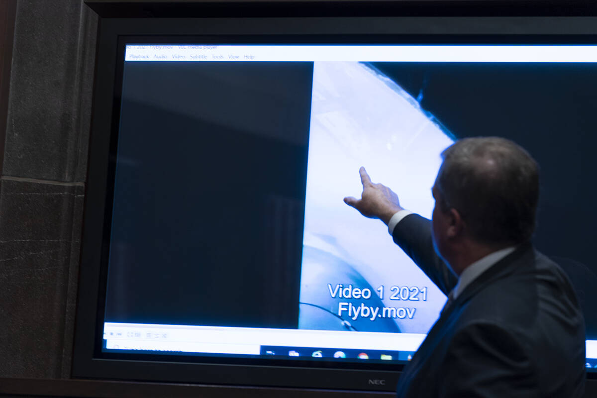 Deputy Director of Naval Intelligence Scott Bray points to a video display of a UAP during a he ...