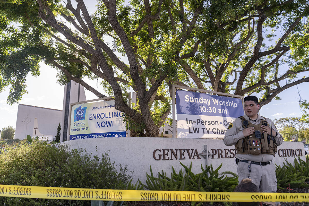 An Orange County Sheriff's Department officer guards the grounds at Geneva Presbyterian Church ...