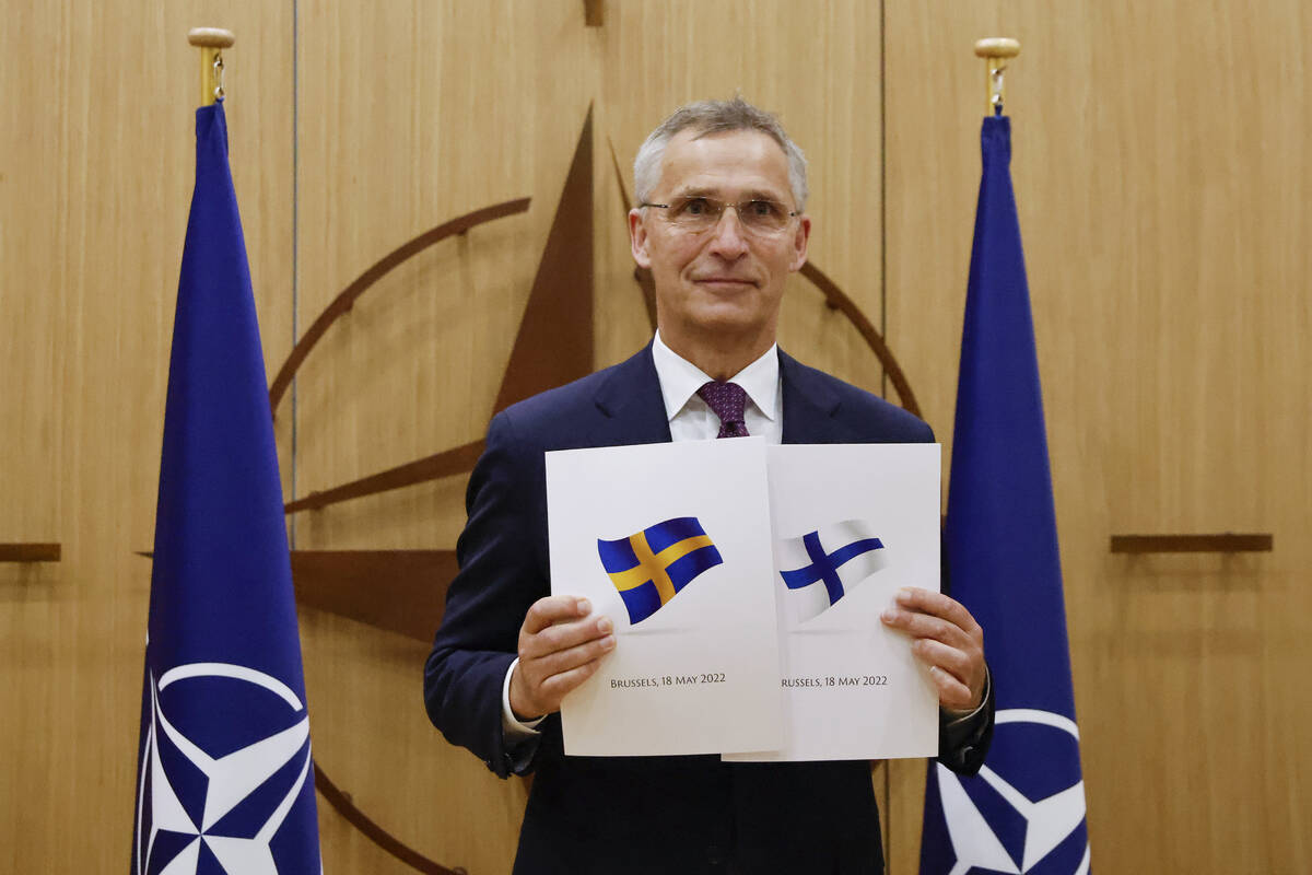 NATO Secretary-General Jens Stoltenberg displays documents as Sweden and Finland applied for me ...