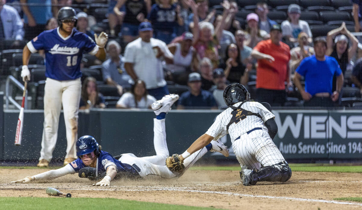 Shadow Ridge runner Brock Morrow (11) slides safely home after a missed tag by Legacy catcher C ...