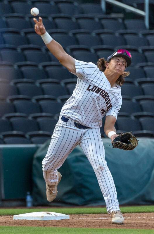 Legacy third baseman Theodore Chartier (8) throws to first base as a Shadow Ridge runner sprint ...