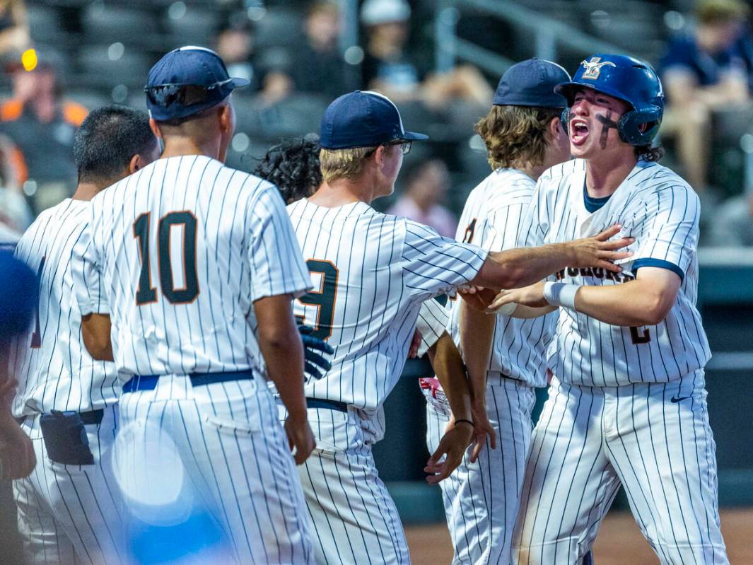 Legacy runner Oscar Pena (2) celebrates another score with teammates against Shadow Ridge durin ...