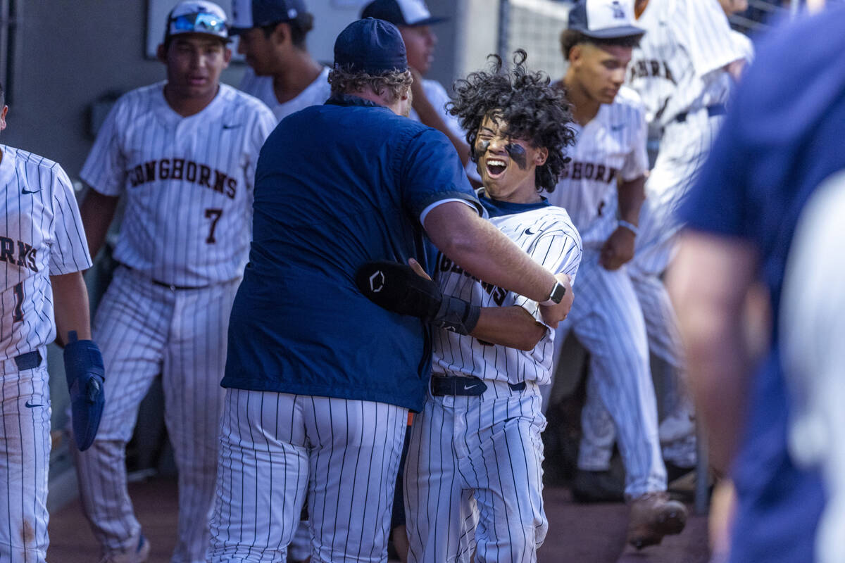 Legacy runner Jericho Gamers (6) celebrates with a coach after scoring against Shadow Ridge dur ...