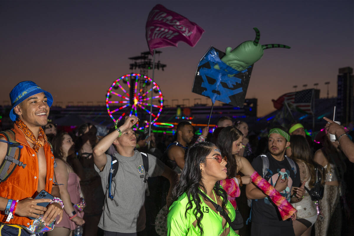 Fans dance to music in between sets during the first day of the Electric Daisy Carnival at the ...