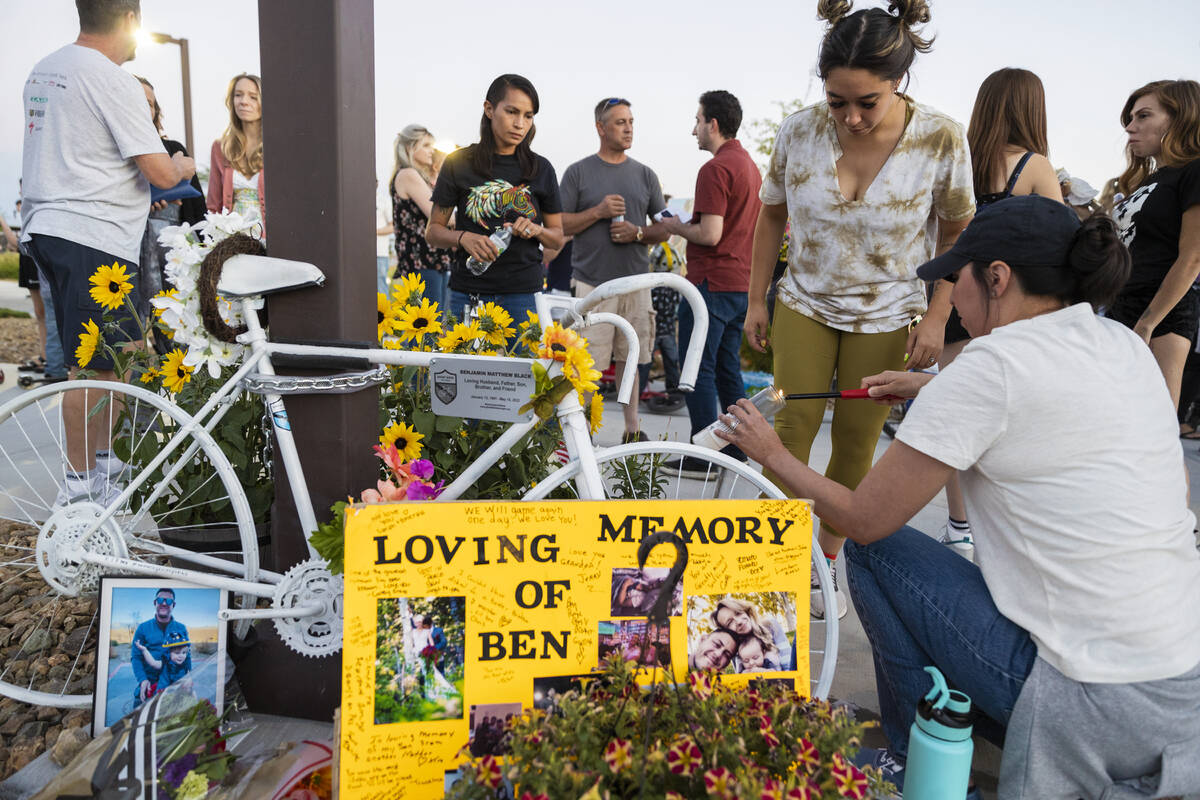 Attendees light candles during a memorial for Ben Black, 31, the bicyclist killed last Sunday i ...
