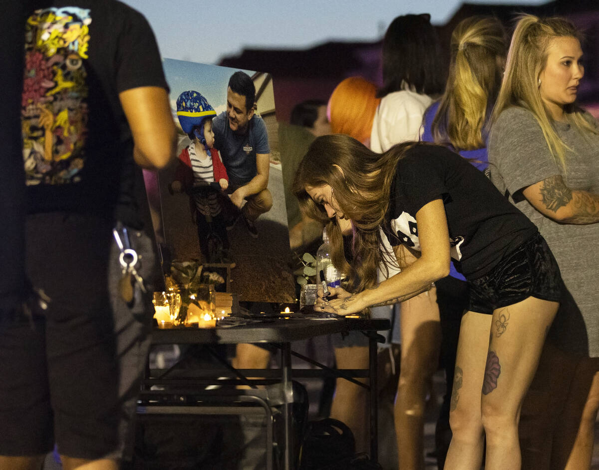 Attendees light candles and write messages during a memorial for Ben Black, 31, the bicyclist k ...