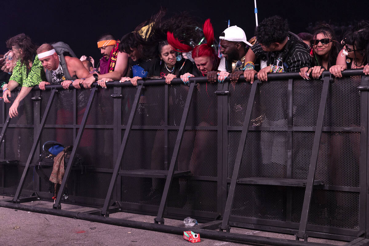 Fans shake the fence while head banging as Riot Ten performs during the first day of the Electr ...