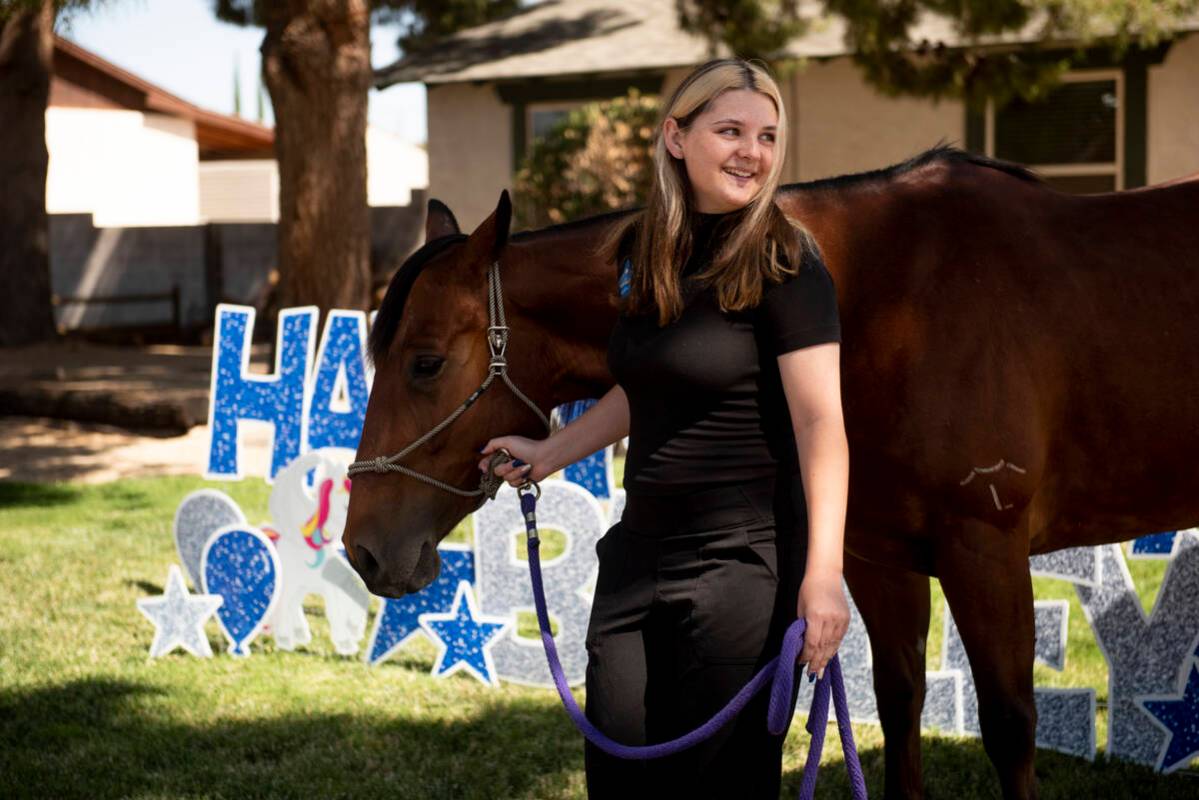 Bailey King, 17, leads her new horse through her front yard on Saturday, May 21, 2022, in Las V ...