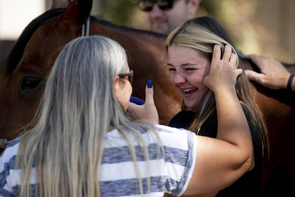Leah King, left, brushes her daughter Bailey's hair from her face as Bailey cries tears of joy ...
