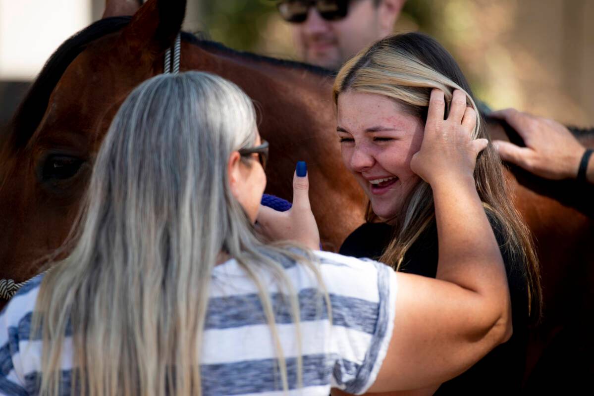 Leah King, left, brushes her daughter Bailey's hair from her face as Bailey cries tears of joy ...
