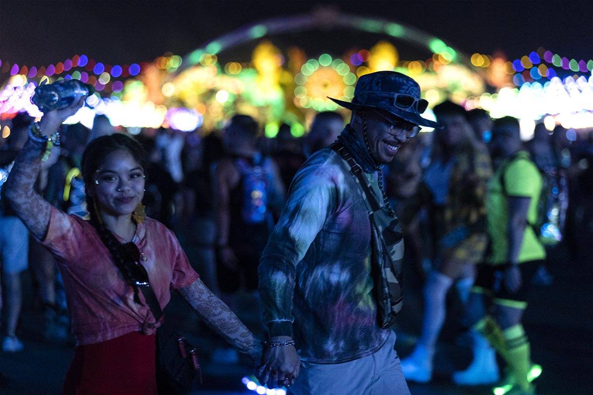Attendees make way to their next destination with the main stage, Kinetic Field, in the backgro ...