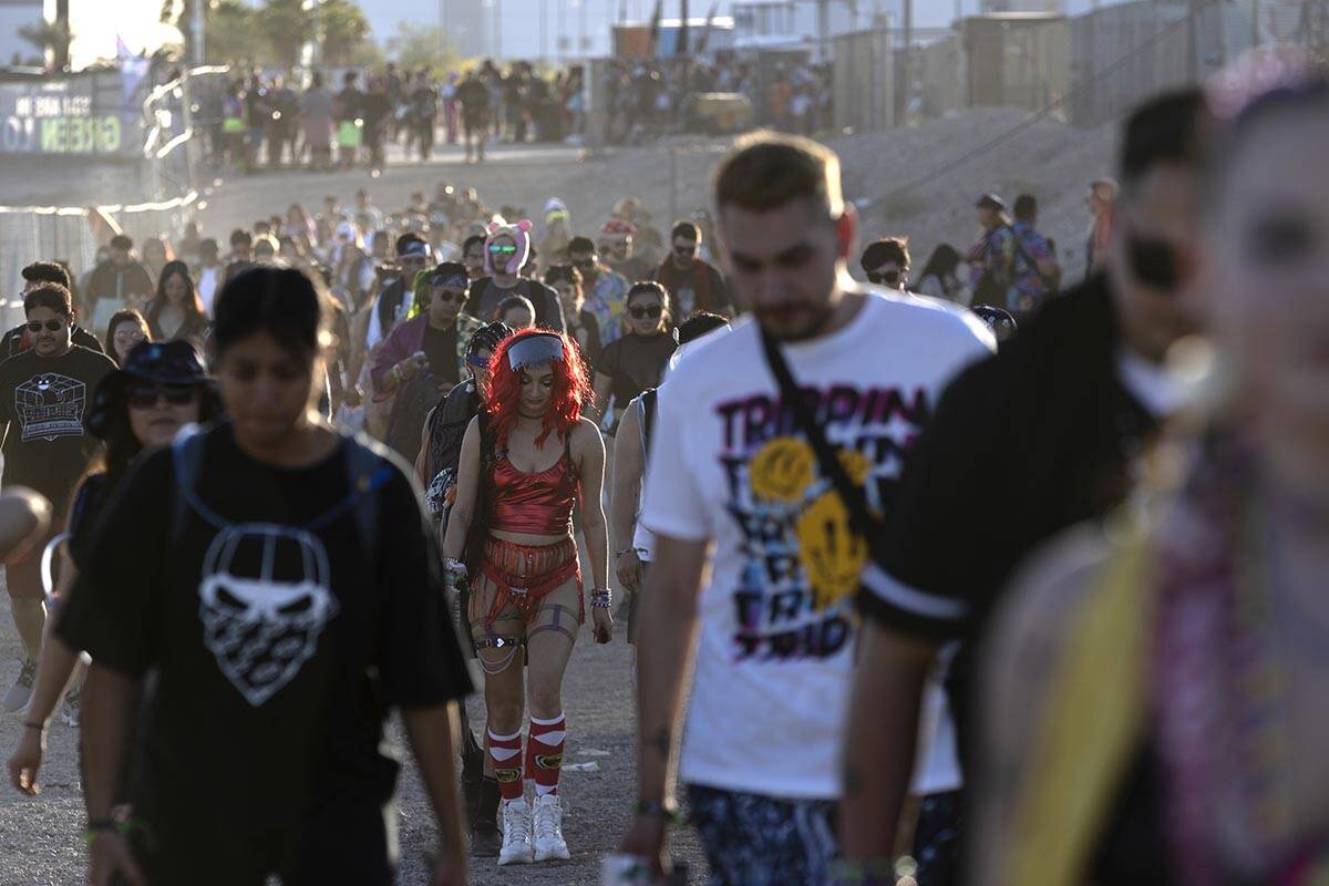 Attendees walk from parking into festival grounds during the second day of the Electric Daisy C ...