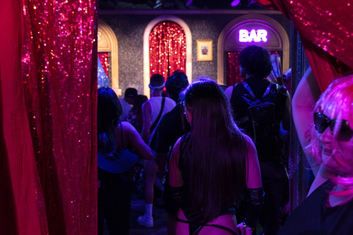 Attendees of the second day of the Electric Daisy Carnival enter The Queen Drag Bar at the Las ...