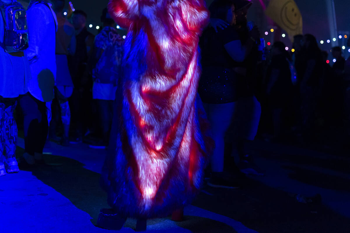 An attendee wears a fur coat and high-heeled boots during the second day of the Electric Daisy ...