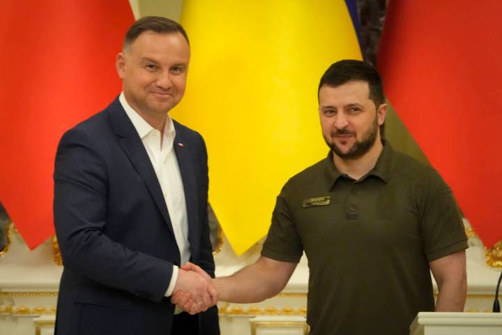 Ukrainian President Volodymyr Zelenskyy, right, and Polish President Andrzej Duda shake hands d ...