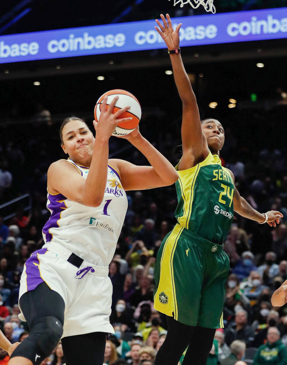 Seattle Storm guard Jewell Loyd, right, goes up against Los Angeles Sparks center Liz Cambage d ...