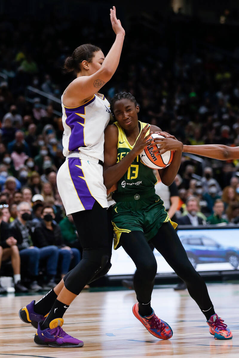 Seattle Storm center Ezi Magbegor collides with Los Angeles Sparks center Liz Cambage during th ...