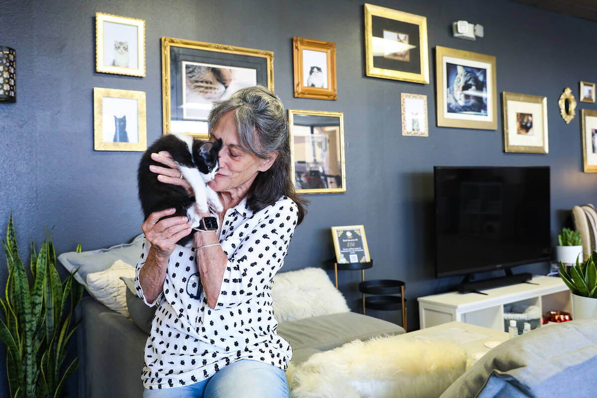 Sue Miller holds Iroh at the Cat Cafe at Hearts Alive Village, a pet adoption center, in Las Ve ...