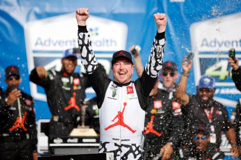 Kurt Busch celebrates in Victory Lane after winning a NASCAR Cup Series auto race at Kansas Spe ...