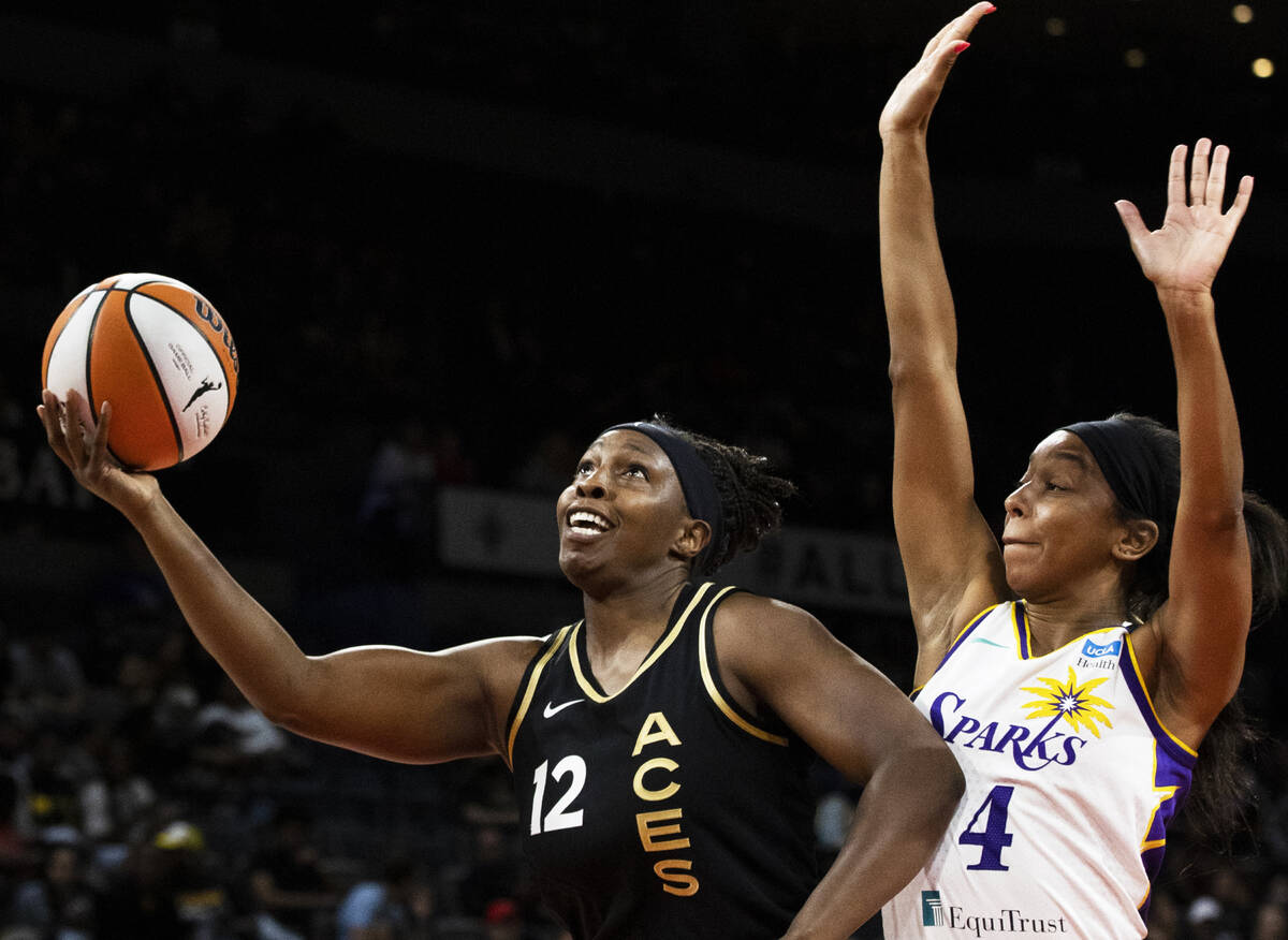 Aces guard Chelsea Gray (12) drives past Los Angeles Sparks guard Lexie Brown (4) in the first ...