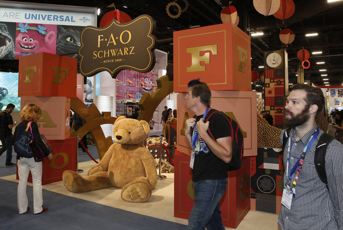Visitors walk past the F.A.O Schwarz booth at the Licensing Expo in May 2018 in Las Vegas. (Biz ...