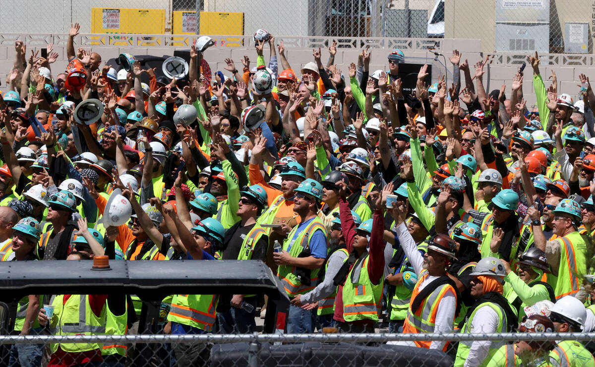 Workers cheer as the final beam is raised to be placed at the top of the MSG Sphere at The Vene ...