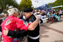 Pearl Harbor survivor Edward Miclavcic, left, and WWII veteran Frank Sacco, right, embrace at a ...