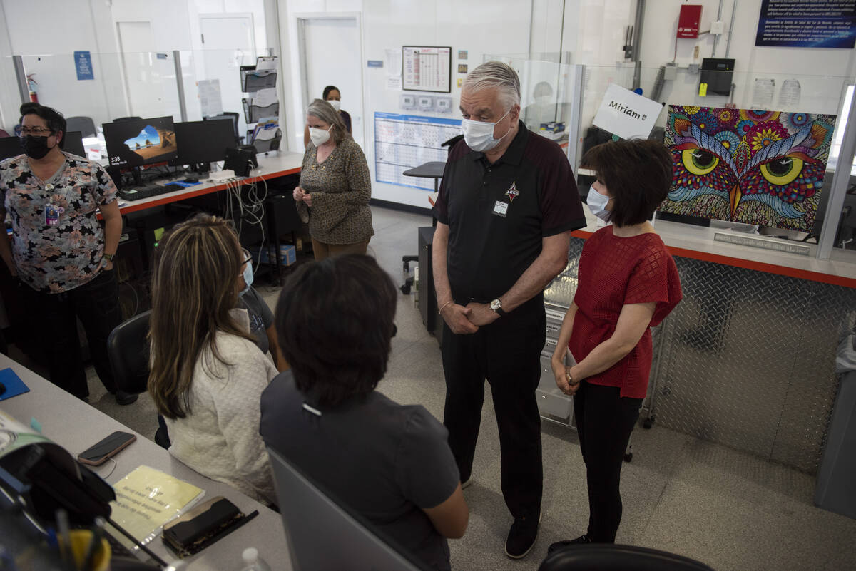 Nevada Governor Steve Sisolak, center, and First Lady Kathy Sisolak, right, talk to staff at th ...