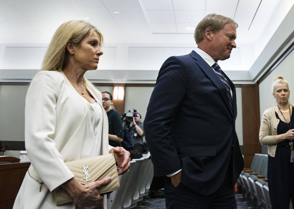 Former Raiders coach Jon Gruden, and his wife Cindy leave the courtroom after appearing at a he ...