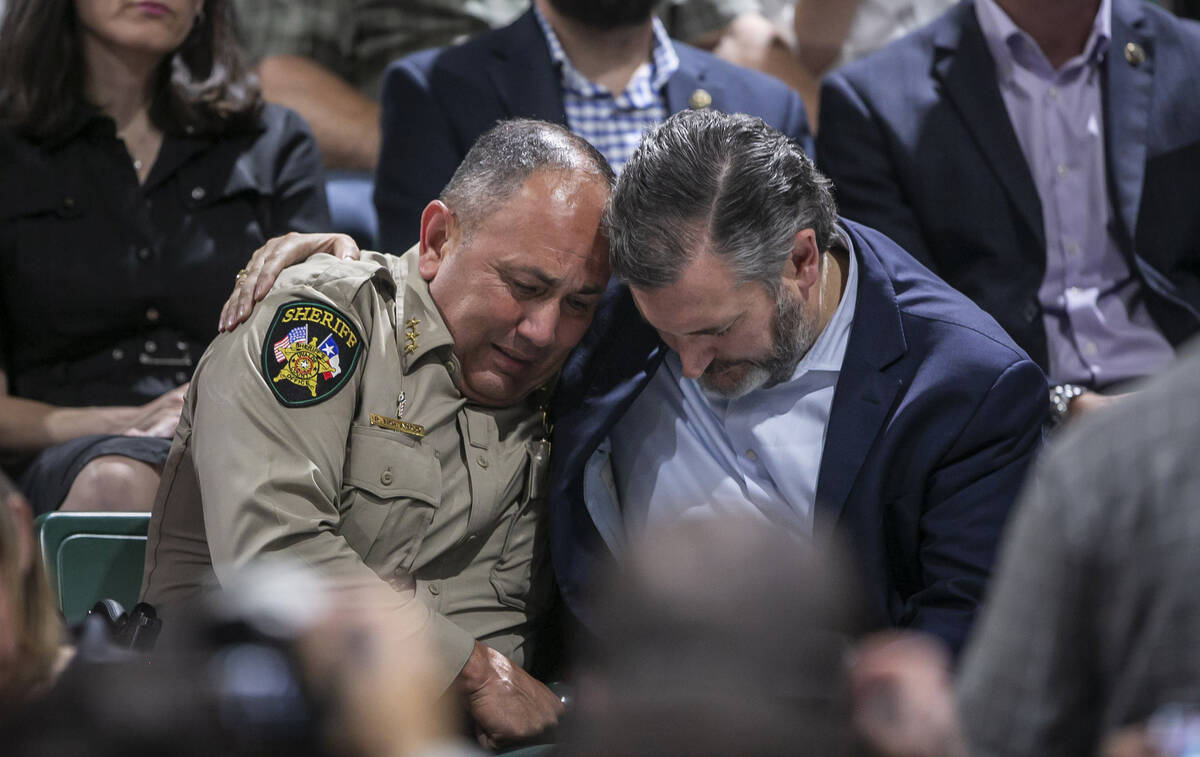 Uvalde County Sheriff Ruben Nolasco, left, is comforted by U.S. Sen. Ted Cruz during a vigil he ...