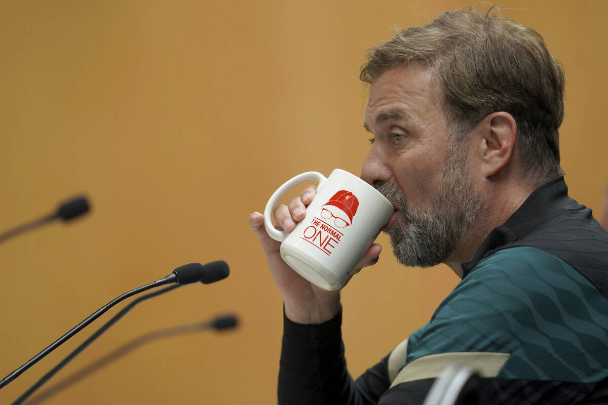 Liverpool's manager Jurgen Klopp drinks during a press conference ahead of the Champions League ...