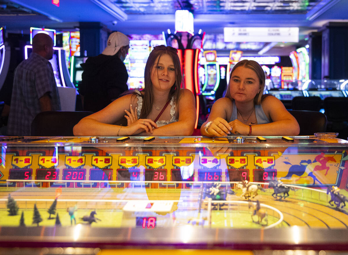 Emily Kissel, left, and Jordyn Keddy, both of Ariz., play the coin-operated Sigma Derby game at ...