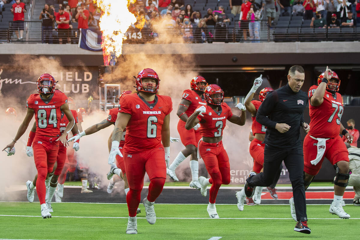 UNLV Rebels head coach Marcus Arroyo leads his team onto the field before the start of an NCAA ...