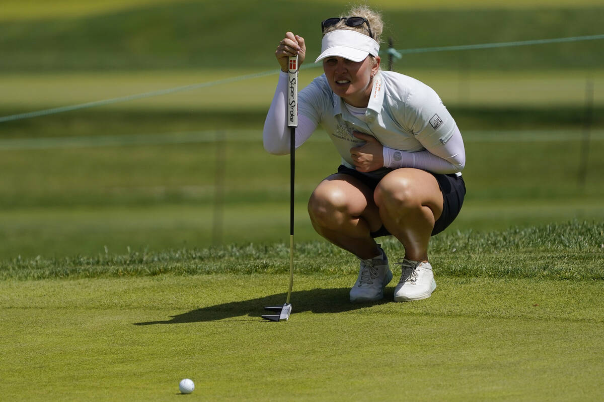 Nanna Koerstz Madsen, of Denmark, lines up a putt on the 15th green during the first round of t ...
