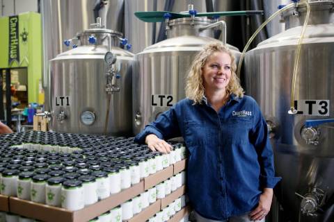 Owner of CraftHaus Brewery Wyndee Forrest stands near in house craft beer in cans at CraftHaus ...