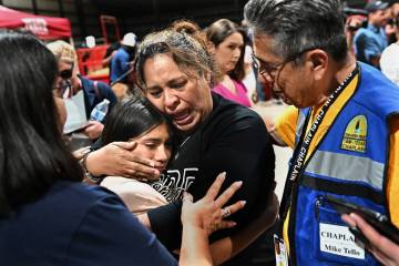 A fourth grade teacher at Robb Elementary school consoles her student after a vigil at the Uval ...