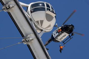 With one of the High Roller cabins just feet away, a Metro police helicopter hovers. The Las Ve ...