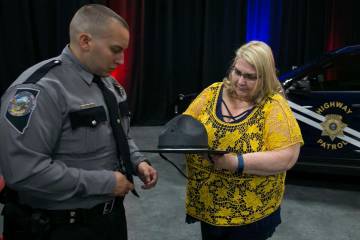 Steven Darnell of Tonopah, Nev. watches as his mother Carol tries to pin his badge after his gr ...