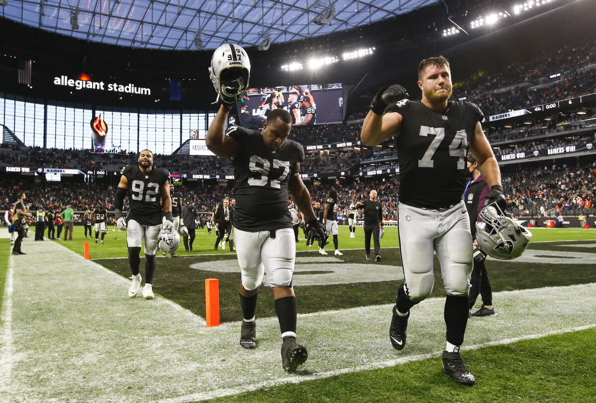 Raiders defensive tackle Damion Square (97) and offensive tackle Kolton Miller (74) celebrate a ...