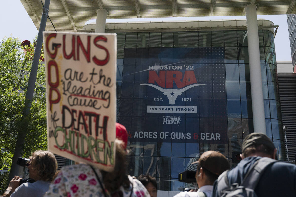 People gather outside the George R. Brown Convention Center to protest the National Rifle Assoc ...