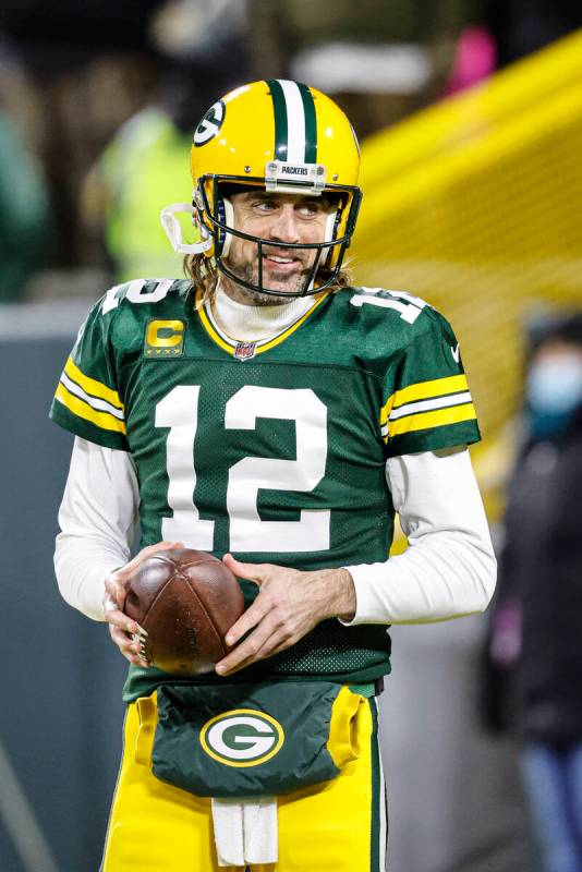 Green Bay Packers quarterback Aaron Rodgers (12) warms up before an NFL divisional playoff foot ...