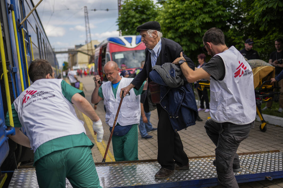 An elderly man boards a medical evacuation train run by MSF (Doctors Without Borders) at the tr ...